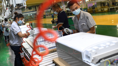Employees wearing masks work on the air conditioner production line at a Gree factory, following the coronavirus disease (COVID-19) outbreak in Wuhan, Hubei province, August 9, 2021. Picture taken August 9, 2021. China Daily via REUTERS ATTENTION EDITORS - THIS IMAGE WAS PROVIDED BY A THIRD PARTY. CHINA OUT.