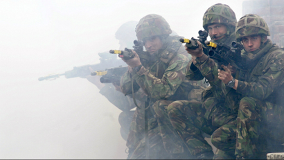 Soldiers from the British Royal Marines Commando demonstrate city fighting techniques.