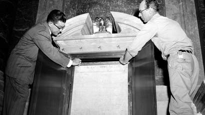 Leroy Morton, left, machinist, and Buck Van Pelt, carpenter, place the original copy of the U.S. Declaration of Independence in a permanent display case in the National Archives Building in Washington, D.C., Dec. 13, 1952.