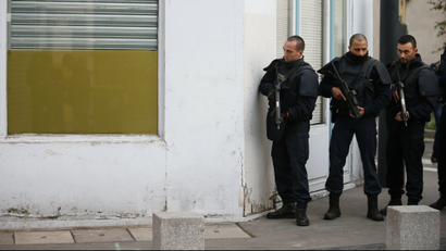 French police secure the area as shots are exchanged in Saint-Denis, France, near Paris, November 18, 2015 during an operation to catch fugitives from Friday night's deadly attacks in the French capital.