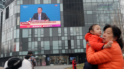 A giant TV screen in Beijing shows Chinese premier Li Keqiang following the closing session of the National People's Congress in March 2022.