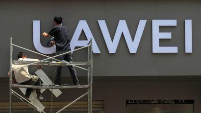 Workers put up a sign for a new Huawei store under construction in Kunming, Yunnan province, China May 29, 2019.