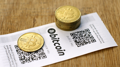 An image of a Bitcoin (virtual currency) paper wallet with QR codes and coins