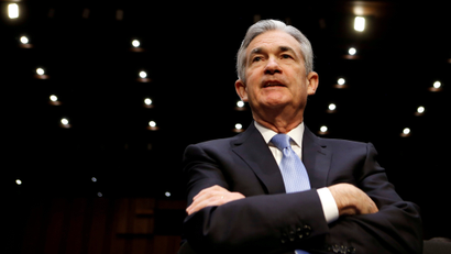 Federal Reserve chair Jerome Powell folds his arms in front of a Congressional committee at a nomination meeting.