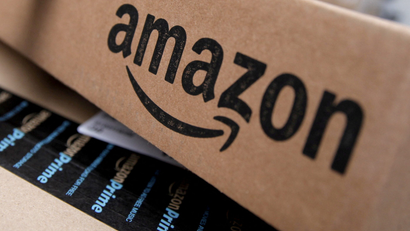 A close-up of two Amazon boxes with the company logo and Prime.