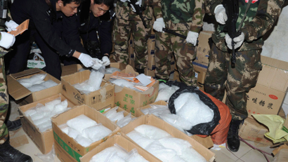 Police check seized crystal meth at Boshe village, Lufeng, Guangdong province, December 29, 2013. According to Xinhua News Agency, Lufeng provided one-third of the crystal meth nationwide over the past three years. Police seized three tonnes of crystal meth and arrested 182 suspects for producing and trafficking drug during the action. Picture taken December 29, 2013.