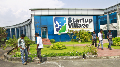 Employees stand outside the Start-up Village in Kinfra High Tech Park in Kochi