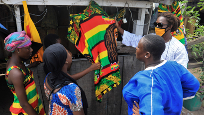 Shoppers examine wares in Abidjan at the outbreak of the coronavirus disease.