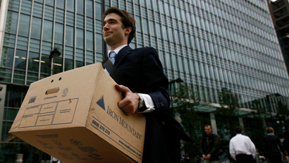 A worker carries a box out of the U.S. investment bank Lehman Brothers offices in the Canary Wharf district of London in this September 15, 2008 file photo.