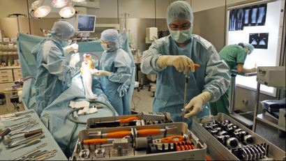 Surgeons in an operating room working on a knee replacement