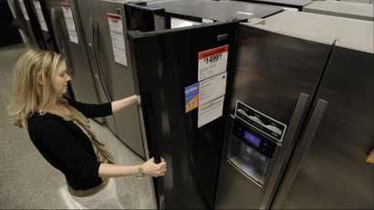 In this photograph taken by AP Images for Sears Holdings Corporation, A consumer checks out a refrigerator at a local Sears’ store. The retailer recently extended its layaway program to include home appliances in an effort to help consumers who haven’t taken advantage of the government’s appliance rebate program. For more information, visit www.Sears.com/layaway. (Paul Beaty/ AP Images for Sears Holdings Corporation