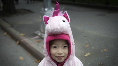 A child in a unicorn costume.