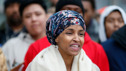 Ilhan Omar, center, the first Somali-American elected to a state legislature, speaks during a rally Tuesday, Nov. 29, 2016, at the Minneapolis-St. Paul International Airport in Minneapolis calling for $15 minimum wages. Those in attendance included airport workers.