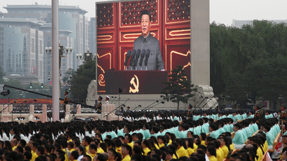 Chinese president Xi Jinping is seen on a giant screen as he delivers a speech
