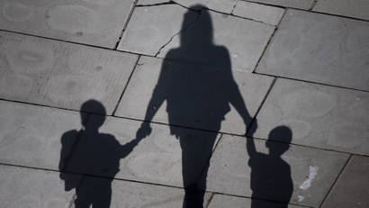 A woman and children cast their shadows