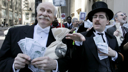 Protesters dressed as Wall Street bankers, march from Goldman Sachs' office to a rally in Chicago's Federal Plaza demanding Wall Street reform.