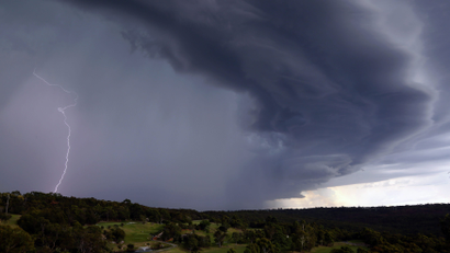 Lightning can be seen as a large storm front crosses over the Sydney suburb of Wakehurst December 5, 2014.