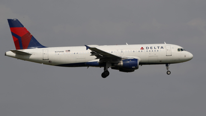 A Delta Air Lines flight against a grey sky.
