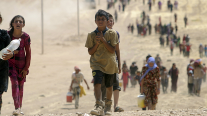 Yazidi people flee Sinjar toward the Syrian border on Aug. 10, 2014.