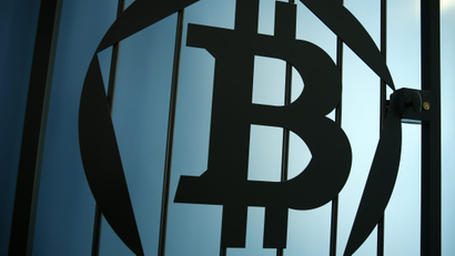 A Bitcoin (virtual currency) logo is pictured on a door at La Maison du Bitcoin in Paris