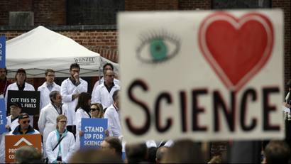a large "I heart Science" poster at a climate rally.