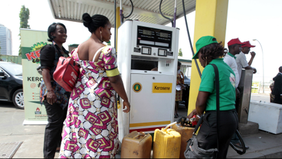 A fuel station attendant dispenses kerosene at a Nigerian National Petroleum Corporation (NNPC) mega petrol station in Abuja.