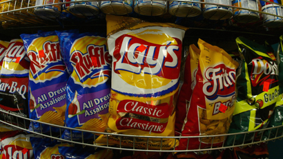 Snack food giant Frito Lay Canada announced February 24, 2004 that it is eliminating trans fat from it's favorite potato chip brands. To remove trans fat, the company will replace hydrogenated oils with corn oil. Frito Lays snacks are seen in a Montreal grocery store, February 24, 2004. REUTERS/Shaun Best SB