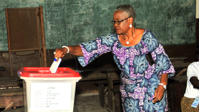 A woman cast her ballot during elections in Cotonou, Benin, Sunday, March 6, 2016. Benin citizens voted Sunday in an election to choose a successor to the West African nation's president, who is stepping down after two terms.