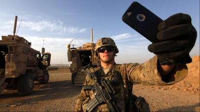 An American soldier takes a selfie at the U.S. army base in Qayyara, south of Mosul