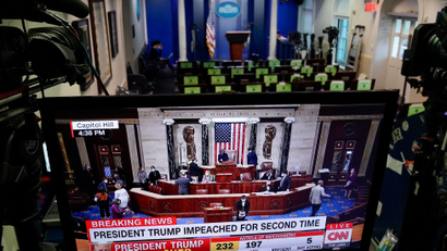 A TV showing Trump's impeachment in front of an empty White House press room