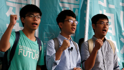 Student leaders (from L) Joshua Wong, Nathan Law and Alex Chow chant slogans before a verdict, on charges of inciting and participating in an illegal assembly in 2014 which led to the "Occupy Central" pro-democracy movement, outside a court in Hong Kong August 15, 2016. REUTERS/Bobby Yip - RTX2KV65