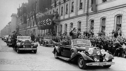 Nazi parade scene with Hitler in a car