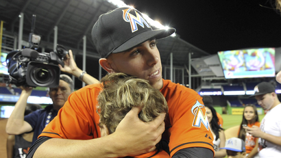 Mar 31, 2014; Miami, FL, USA; Miami Marlins starting pitcher Jose Fernandez (16) embraces his grandmother Olga Fernandez after defeating the Colorado Rockies 10-1 on opening day baseball game at Marlins Ballpark. Mandatory Credit: Steve Mitchell-USA TODAY Sports