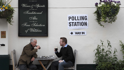 Men drink at a pub being used as a polling station