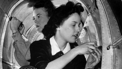 Two women are seen working the production line at Grumman Aircraft Engine Corp., at an unknown location in 1943. (AP Photo)