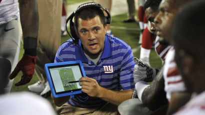 New York Giants tight ends coach Kevin Gilbride uses a Microsoft Surface tablet at the Pro Football Hall of Fame exhibition NFL football game against the Buffalo Bills Sunday, Aug. 3, 2014, in Canton, Ohio. New York won 17-13. (AP Photo/David Richard)