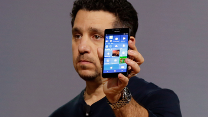 Microsoft vice president for Surface Computing Panos Panay shows a new Lumia 950 phone during a presentation, in New York, Tuesday, Oct. 6, 2015. The device will work with an optional dock. Users can attach a regular monitor, keyboard and mouse and work with apps on the phone just like you would on a Windows 10 desktop. (AP Photo/Richard Drew)