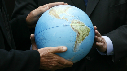 People holding a globe.