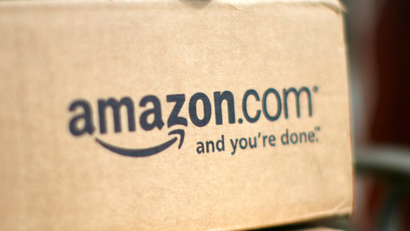A box from Amazon.com is pictured on the porch of a house