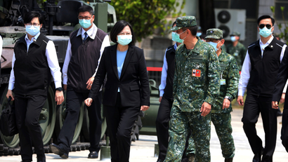 Taiwanese president Tsai Ing-Wen and soldiers wear face masks