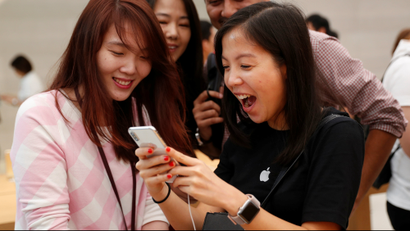 People look at iPhone X at the Apple store in Singapore