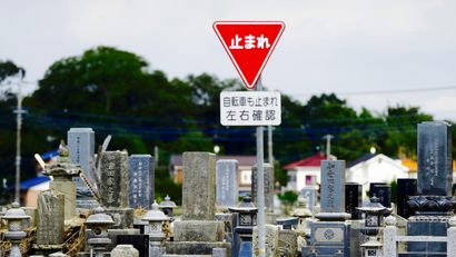 Stop sign by a cemetery in Japan.