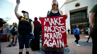 Protestor holding sign that says "Make Racist Afraid Again".