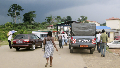 People wait to cross the border into Equatorial Guinea by car and by foot in Kye-Ossi
