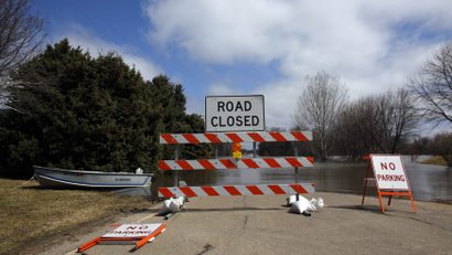 A road covered in water is closed off to traffic in the Burke Addition neighborhood of Grand Forks, North Dakota April 13, 2011.