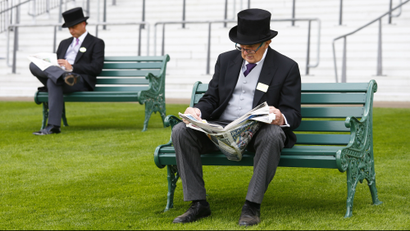 Men in traditional suits reading newspapers