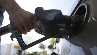 A motorist puts gas in his car