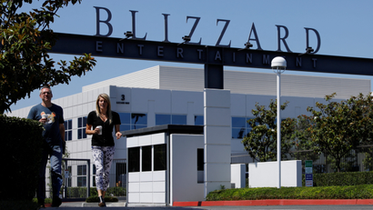 Two employees walk out of the entrance to Activision Blizzard's headquarters.