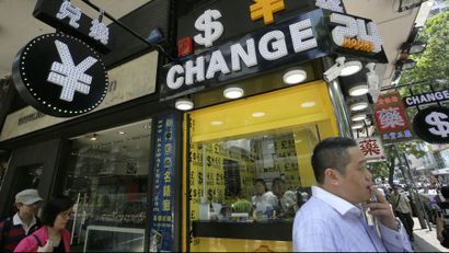 A man walks past a currency exchange shop in Hong Kong.