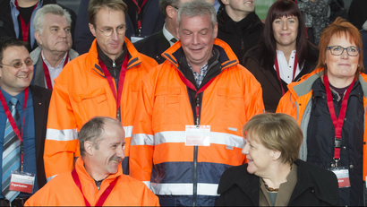 German Chancellor Angela Merkel smiles during a meeting with construction workers
